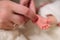 A father strokes a newborn baby`s heel