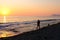 Father and sun walking on beach at sunset