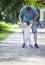 Father supporting baby daughter and helping her make first steps