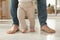 Father supporting his baby daughter while she learning to walk at home, closeup