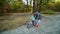 Father supporting little daughter while she riding bicycle