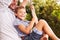 Father swinging with son at a playground