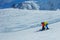 Father teach boy glide behind hold ski bindings with hands