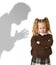 Father or teacher shadow screaming angry reproving young sweet little schoolgirl or daughter