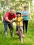 Father teaches his daughter to ride a bike