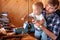 Father teaches his toddler son to use tools vise and rasp in a workshop. Cute boy exploring new stuff. Fatherhood concept