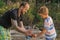 Father teaches son how to hammer a nail