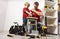 Father teaches son to work with a hand drill.