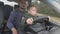 Father teaches two year old son to drive car.