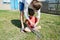 Father teaching boy in machete sharpening