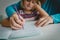 Father teaching daughter how to write letters