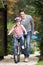 Father Teaching Daughter To Ride Bike In Garden