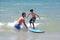 Father teaching his young son to surf