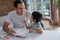 Father teaching letter to her daughter at home