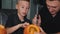 Father teaching son how to carve pumpkins for halloween