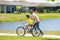 Father teaching son riding bike. Father helping excited son to ride a bicycle in american neighborhood. Child in bike