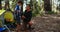 Father teaching son to use trekking pole outside tent