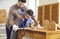 Father teaching son use sharp handsaw for woodworking at home carpentry workshop