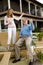 Father and teen daughter playing air guitar