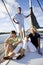 Father and teenage children on sailboat at dock