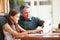 Father And Teenage Daughter Looking At Laptop Together