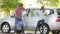 Father And Teenage Daughter Washing Car Together