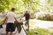 Father And Teenage Son Putting Up Tent On Camping Trip