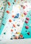 Father and teenage son sitting near the indoor climbing wall. They resting after the active climbing. Happy parenting concept