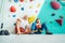 Father and teenage son sitting near the indoor climbing wall. They resting after the active climbing. Happy parenting concept