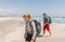 Father with teenager son with backpacks walking by the sandy seaside beach during Lycian Way trekking walk. Famous Likya Yolu