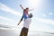 Father Throwing Daughter Into Air On Beach