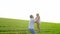Father throwing happy child girl daughter air sunset in the green field. Father playing with little daughter. He throws