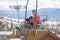 Father & Toddler Son On a Ski Lift with the Snowy Colorado Mountain Resort in the Background