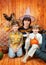 The father and two boys sit with pumpkins