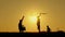 Father and two children playing with a kite in nature. The unity of the family and outdoor recreation.