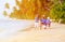 Father and two kids collecting shells on beach