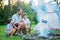 Father and two sons camping in the forest, summertime