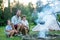 Father and two sons camping in the forest, summertime