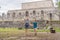 Father and two sons tourists observing the old pyramid and temple of the castle of the Mayan architecture known as