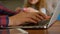 Father using laptop while daughter playing with clay in living room