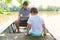 Father video chat on laptop in boat with son