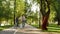 Father walk and help son ride tricycle on pavement