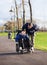 Father walking with disabled son in wheelchair