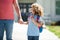 Father walking son to school. Parent and pupil of primary school schoolboy. Kid elementary student carrying backpacks