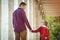 Father walking to school with kid girl. Back to school. Back view of child and dad. Pupil of primary school