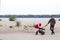 The father walks with his child in baby carriage in the park by