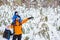 Father walks with his young children in the woods in winter