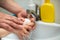 Father washes hands with soap to  son for corona virus prevention