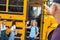 Father waving to son going to school by bus happy