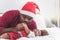 Father wearing a red Christmas hat and kissing hand  his 4-month-old baby newborn son